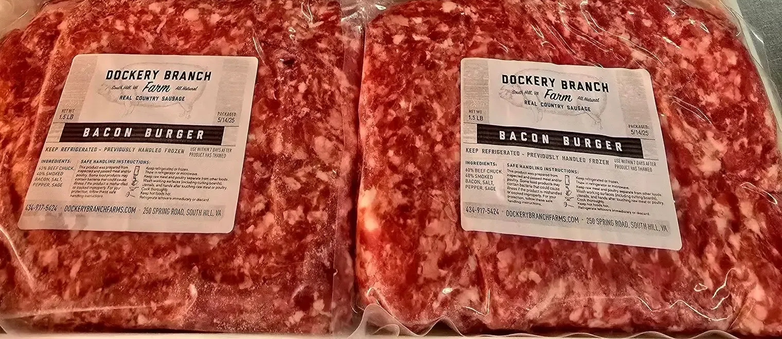 Two vacuum-sealed packages of ground meat with white labels, side-by-side, on a surface.