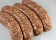 Four raw pork sausages arranged diagonally on a white background.