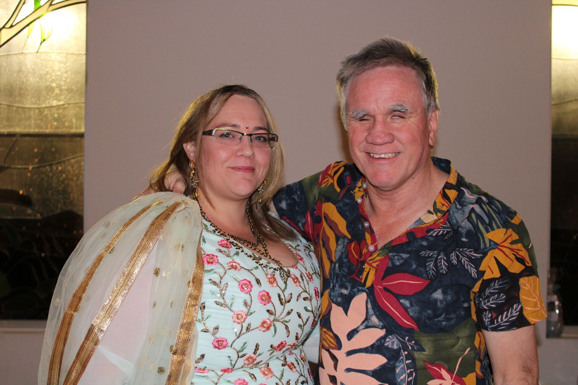 A man and a woman are posing for a picture together.