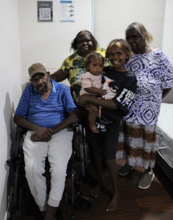 A group of people posing for a picture with one wearing a shirt that says ea