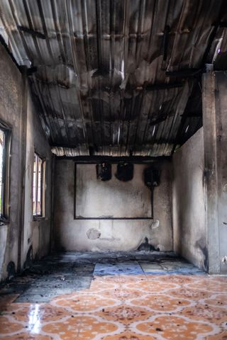 An empty room with a tiled floor and a metal roof.