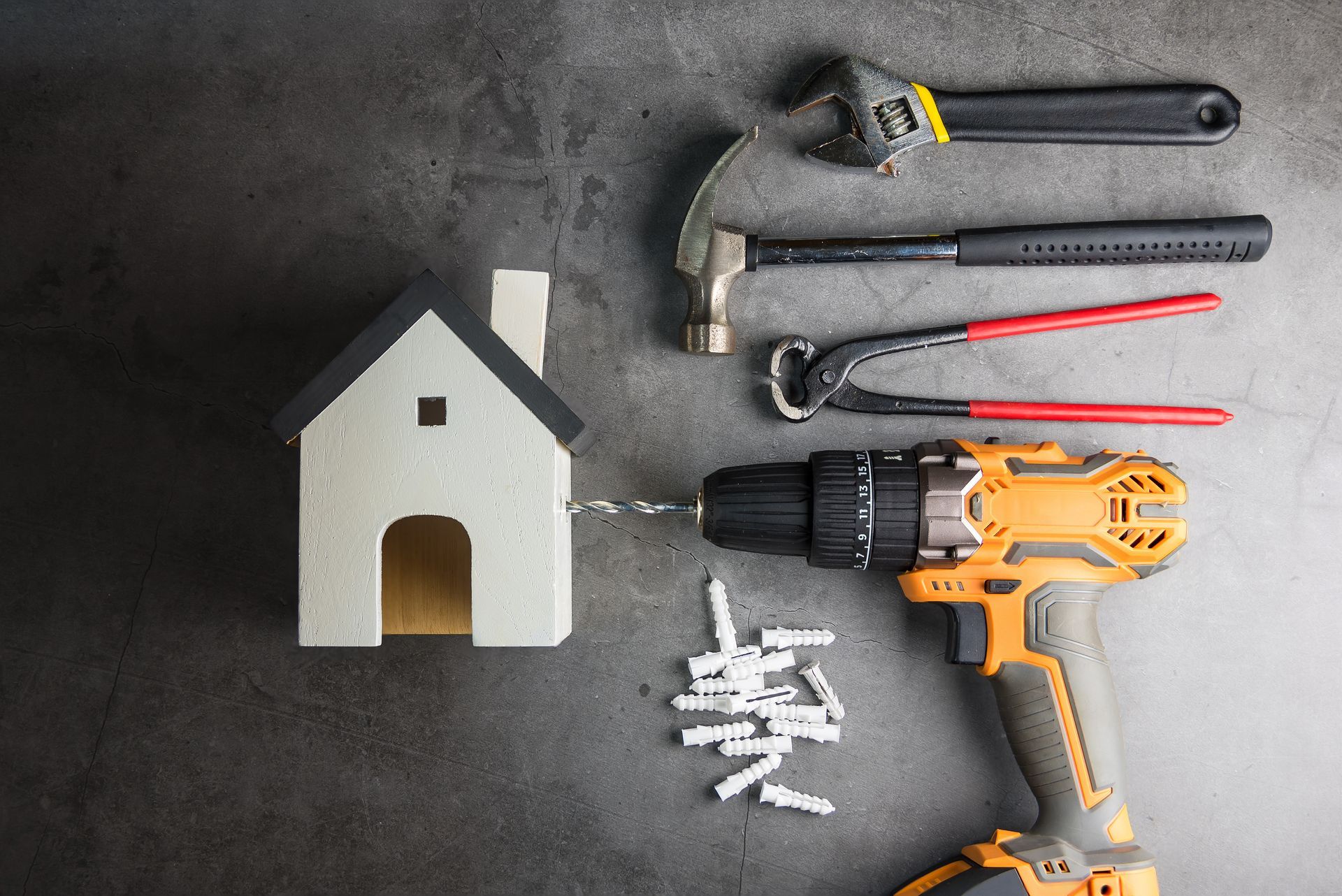 A drill is being used to drill a hole in a model house.