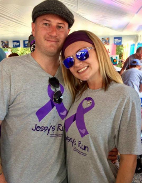 A man and a woman wearing jessy 's run shirts