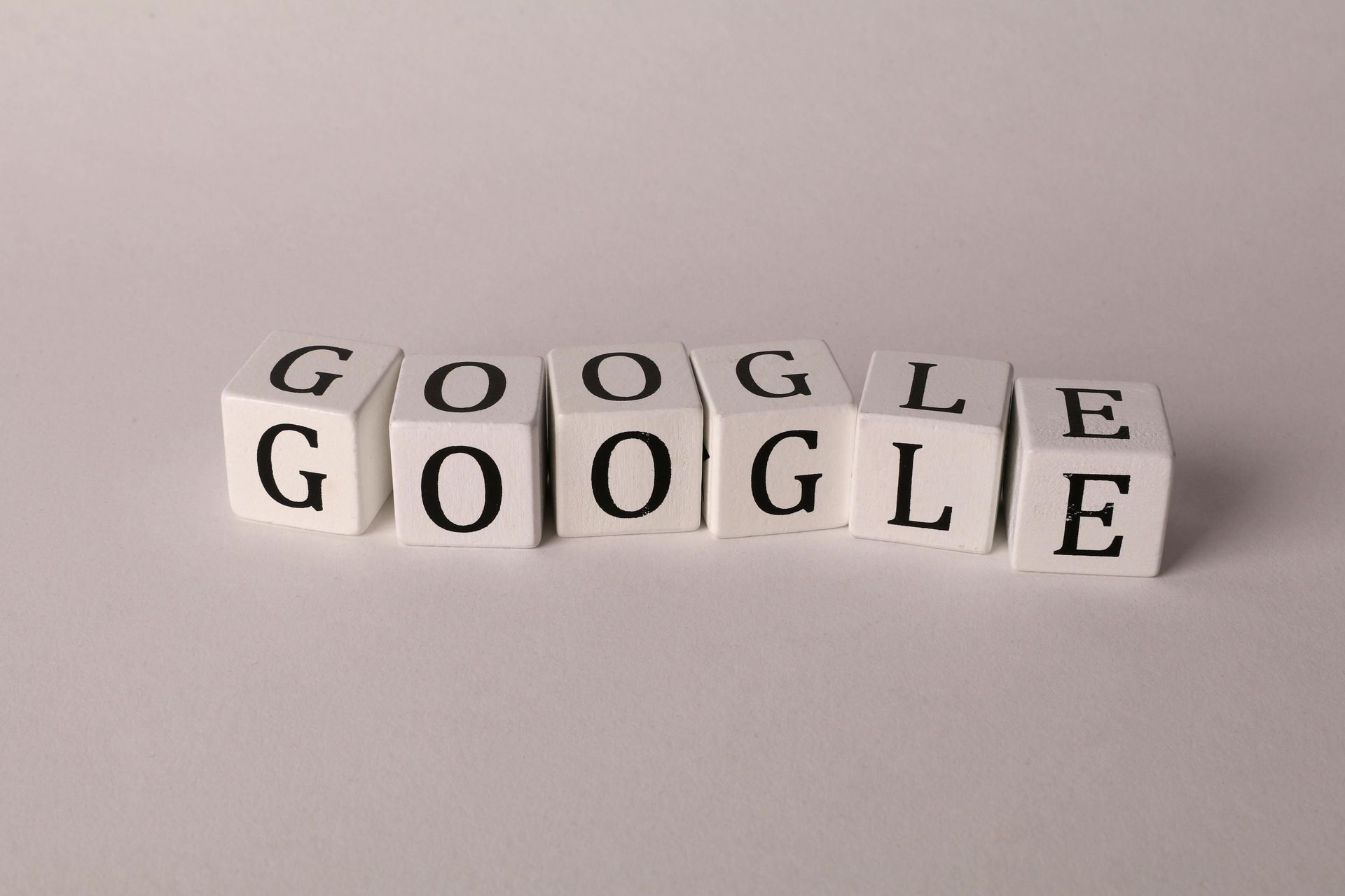 White letter blocks spelling “Google” on a light background
