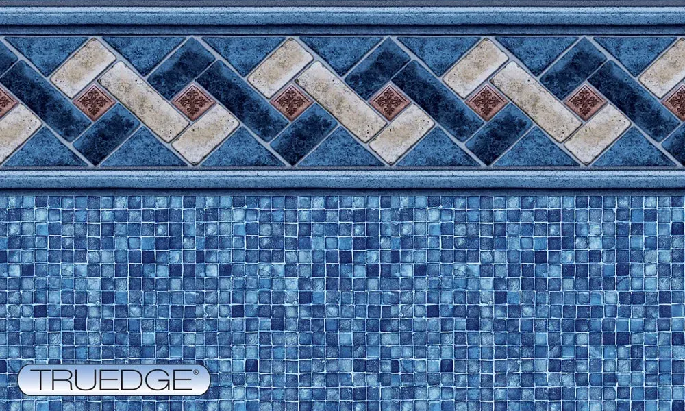 A close up of a blue tile wall with a border.