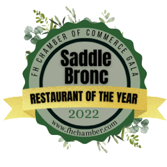 Saddle Bronc Restaurant of the Year 2022 award logo with green, gold, and white elements.