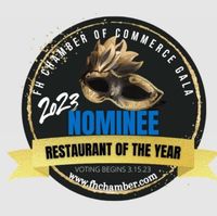 Saddle Bronc Restaurant of the Year 2022 award logo with green, gold, and white elements.