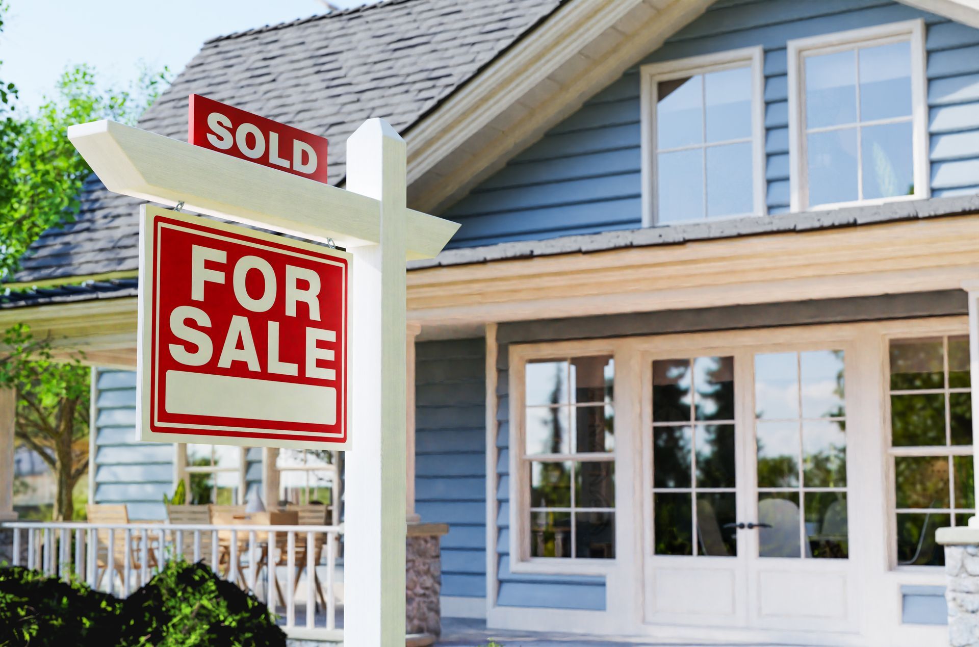A house with a for sale sign in front of it