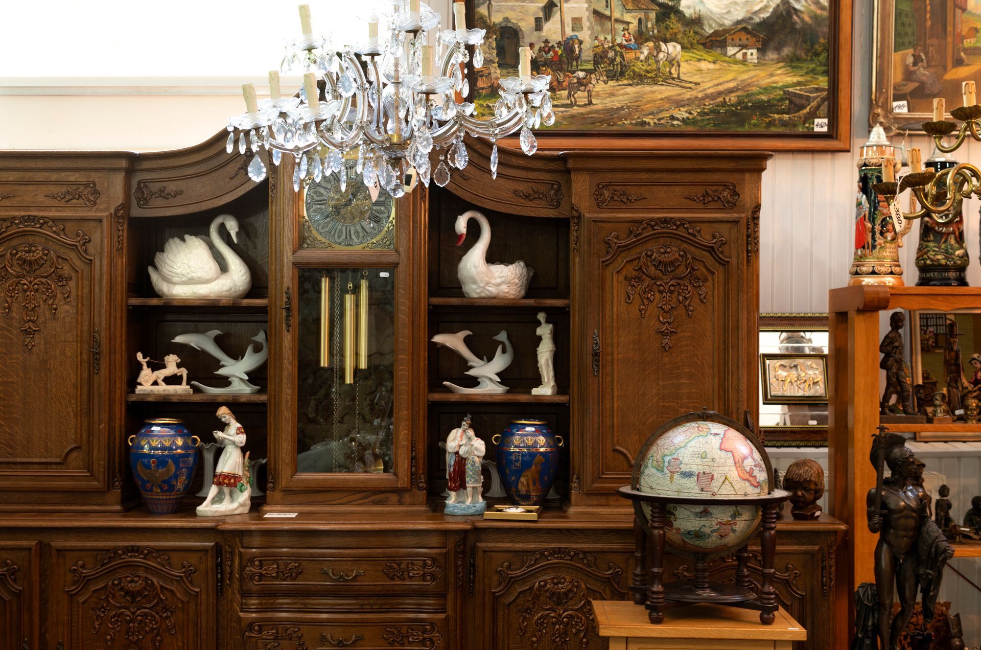 A room filled with lots of antique furniture and a globe.