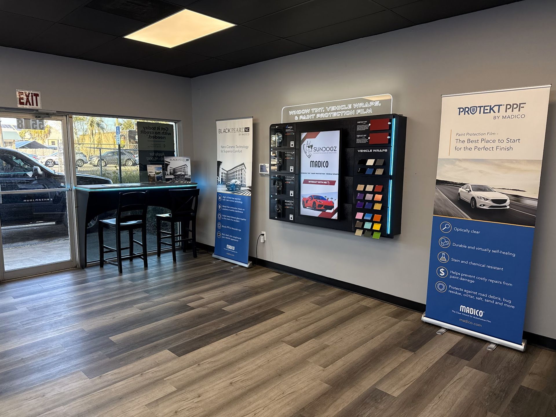 Interior car shop with a vending machine and promotional banners.