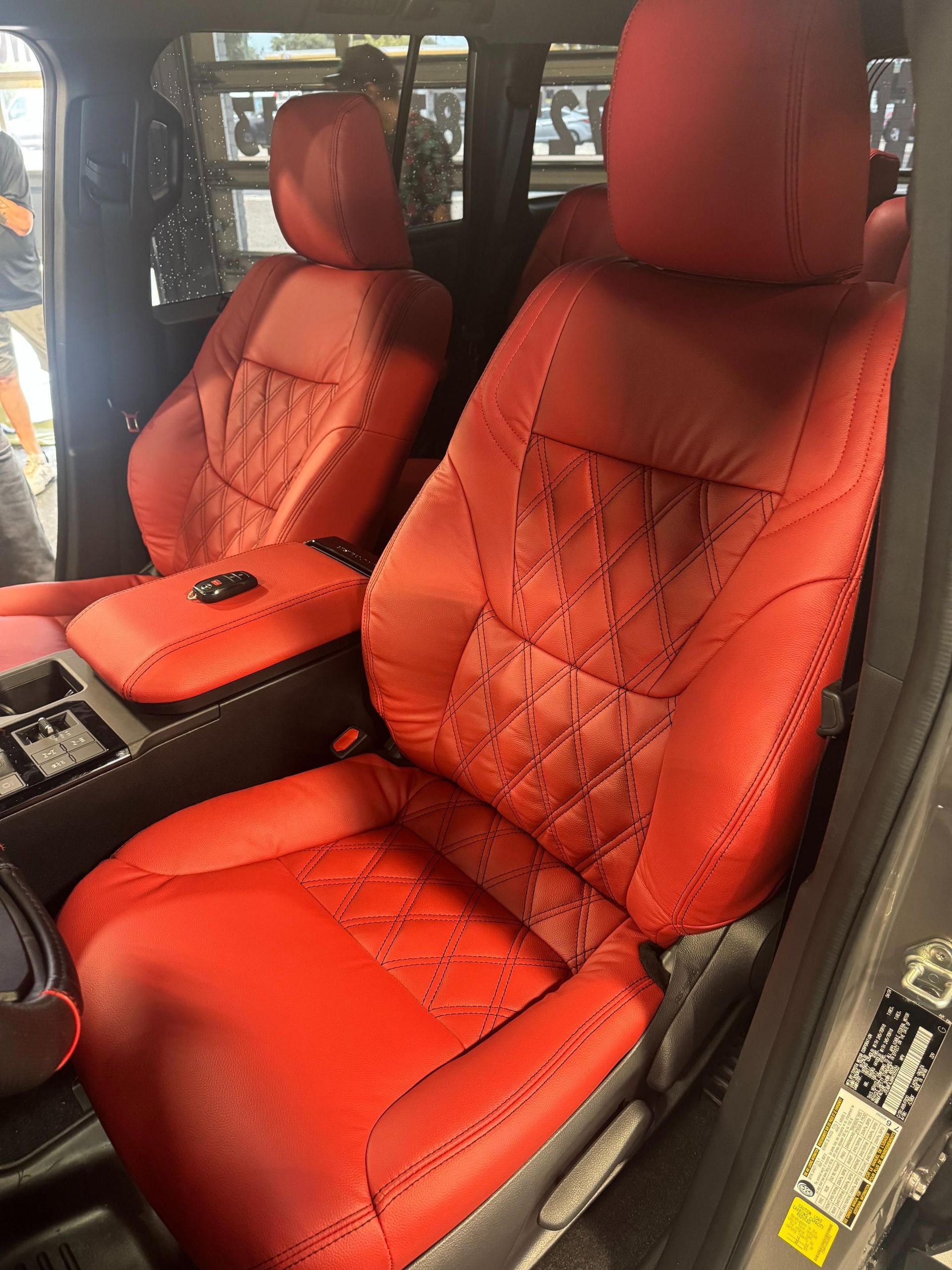 Red leather car seats with diamond stitching.