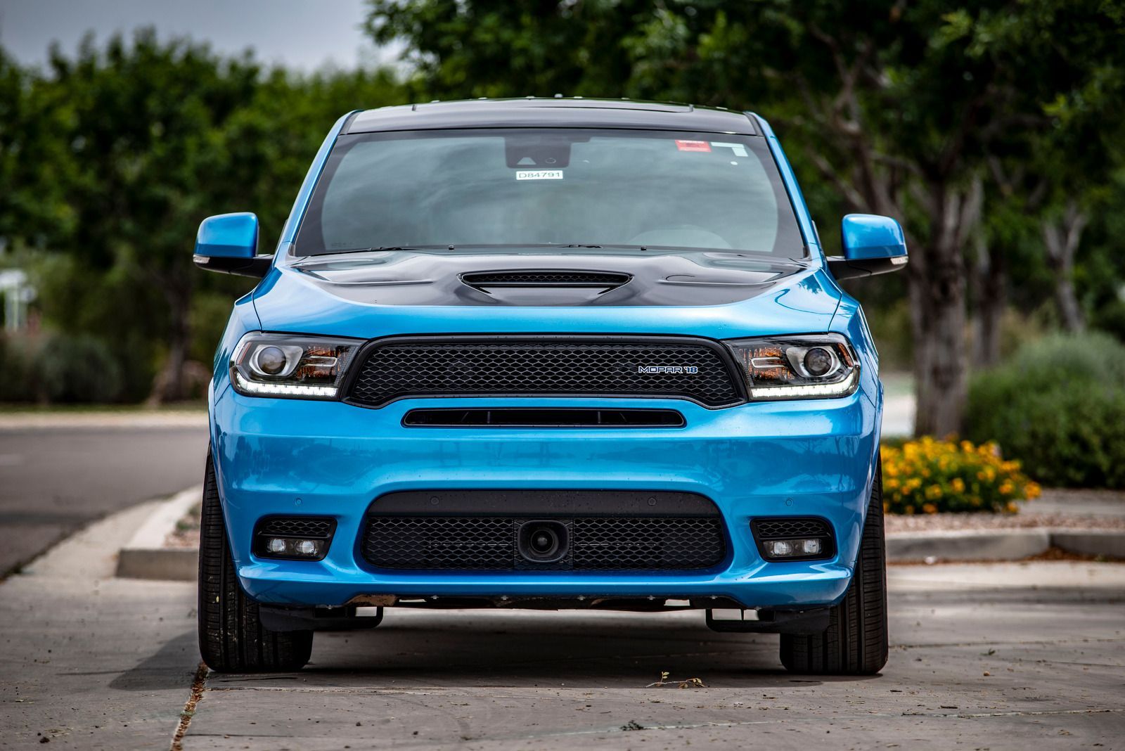 Blue Dodge Durango SUV with black hood, grille, and trim, parked outdoors.