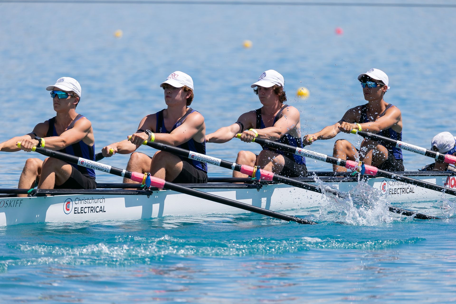 CBHS rowing team on the water with Christchurch Electrical logo on boat.