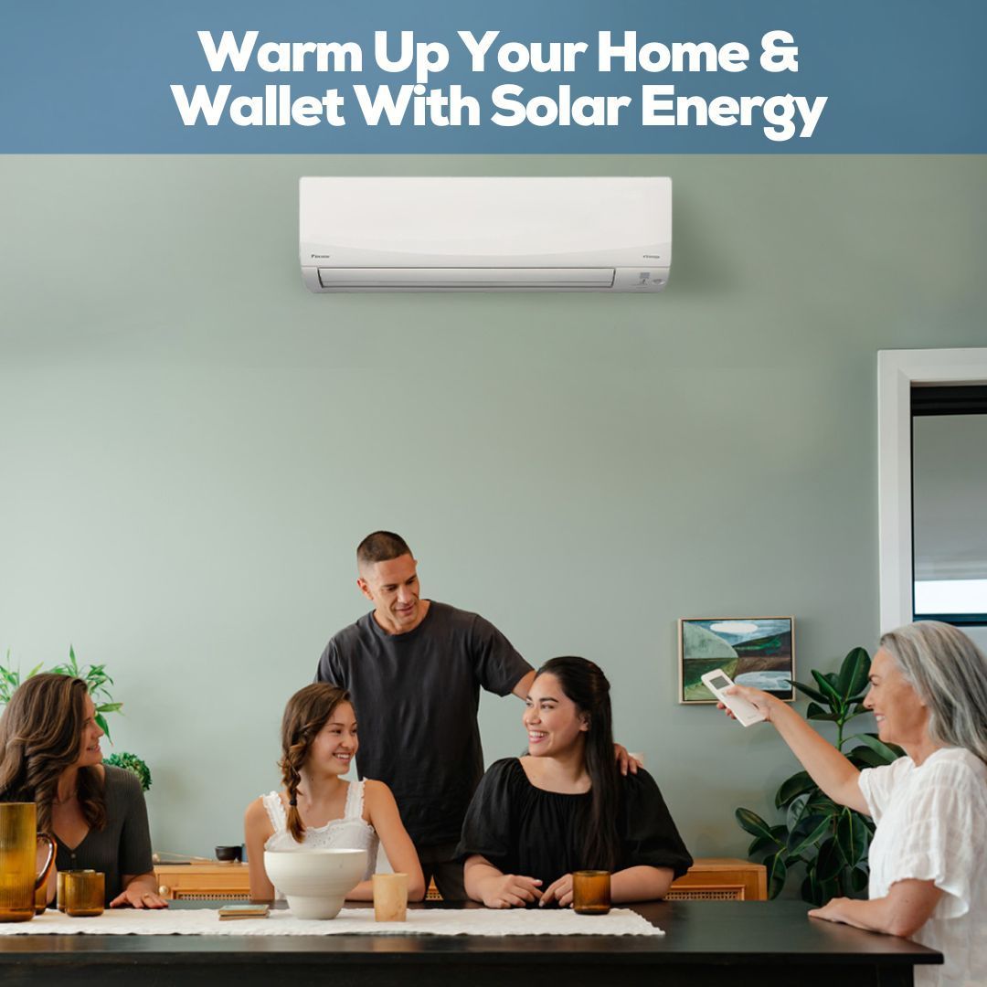 Family sitting around a dining table with a heat pump on the wall