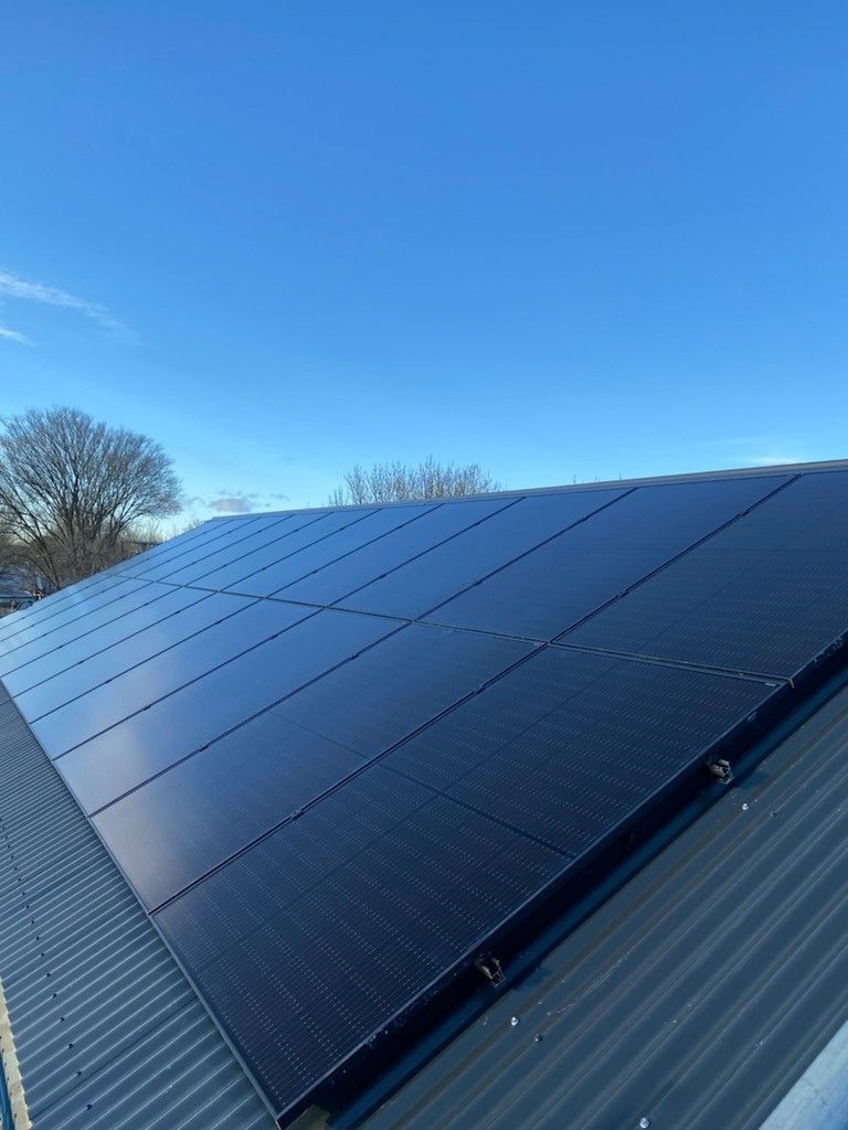 Black solar panels on residential roof.