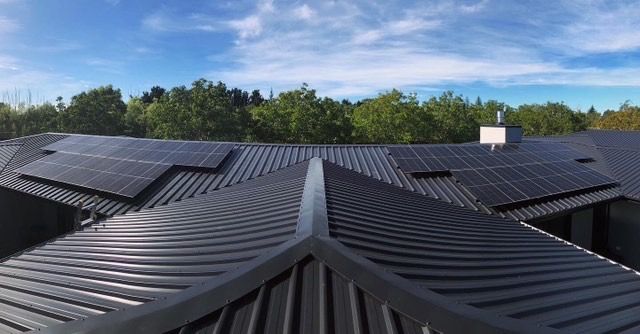 Black solar panels on residential roof in Christchurch, NZ.