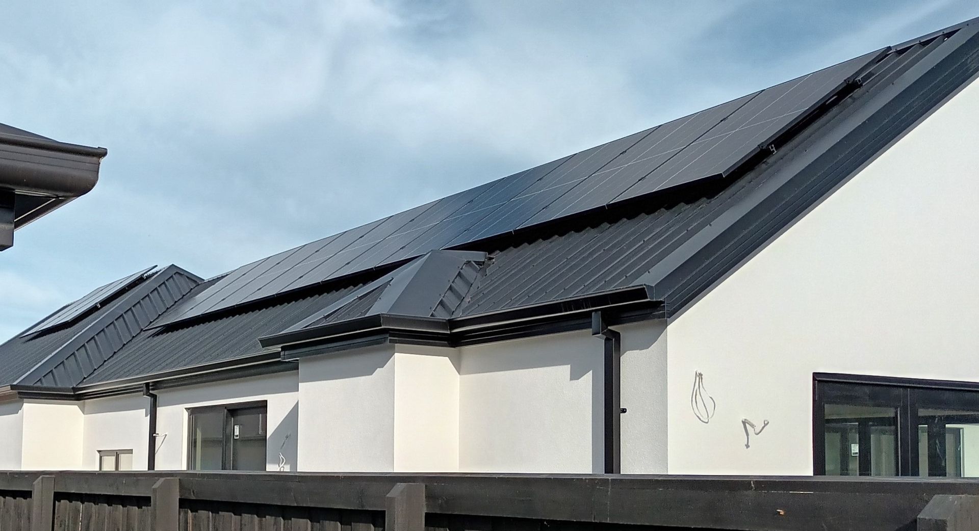 Black solar panels on residential roof in Christchurch, NZ.