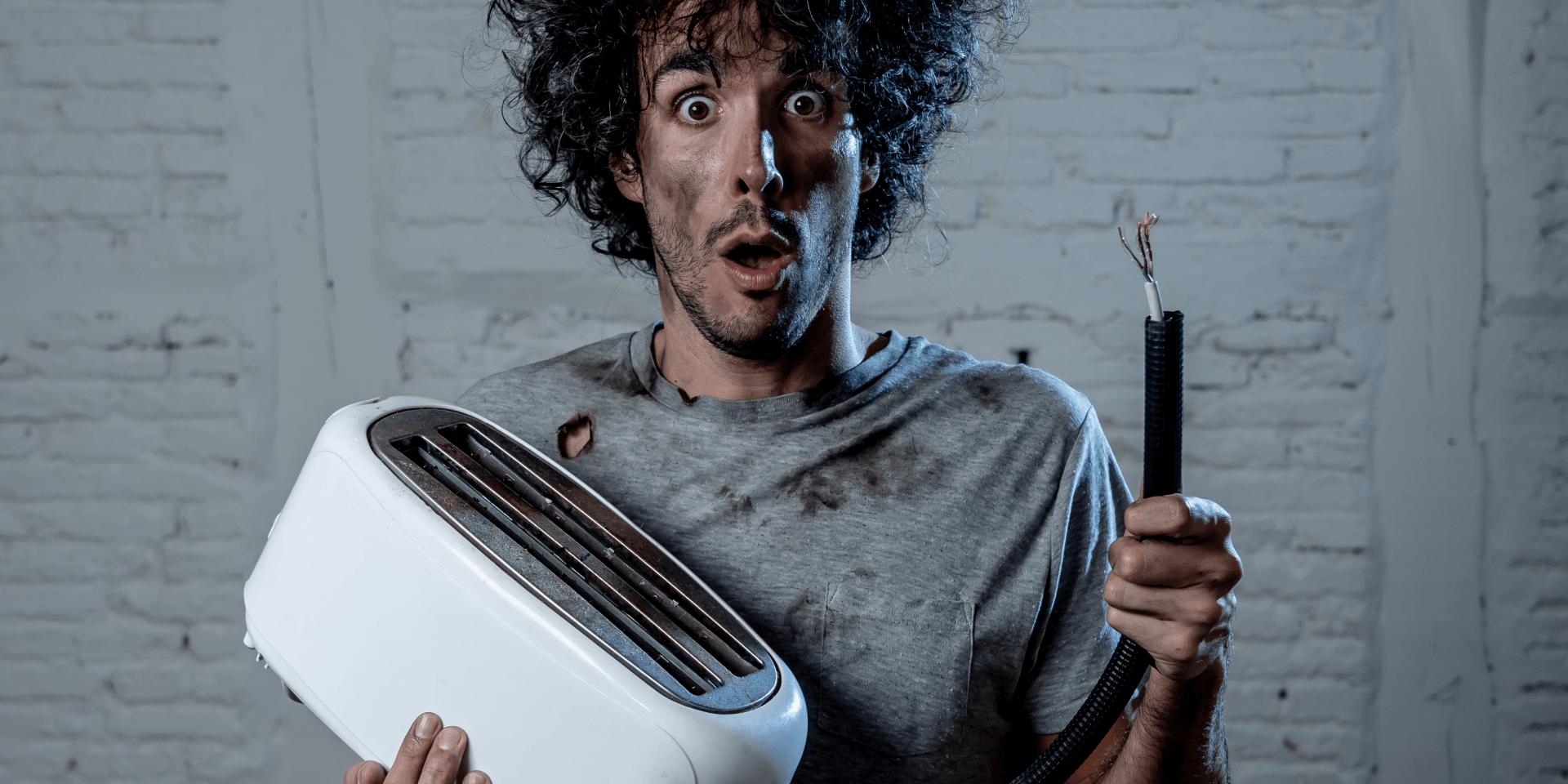Man holding toaster - electric shock