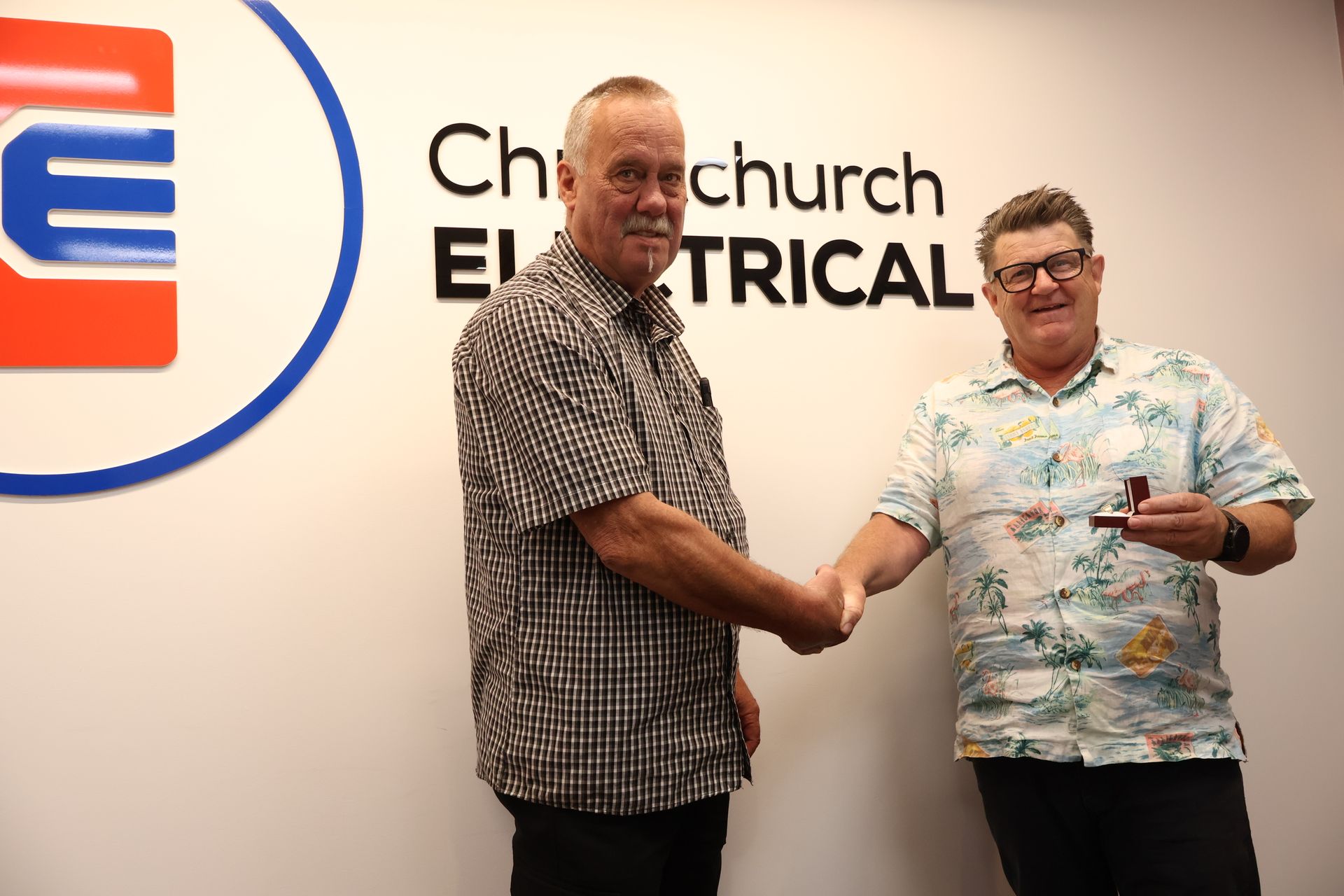 Bruce Davison being presented with a gold ring by Rex Prebble of Christchurch Electrical.