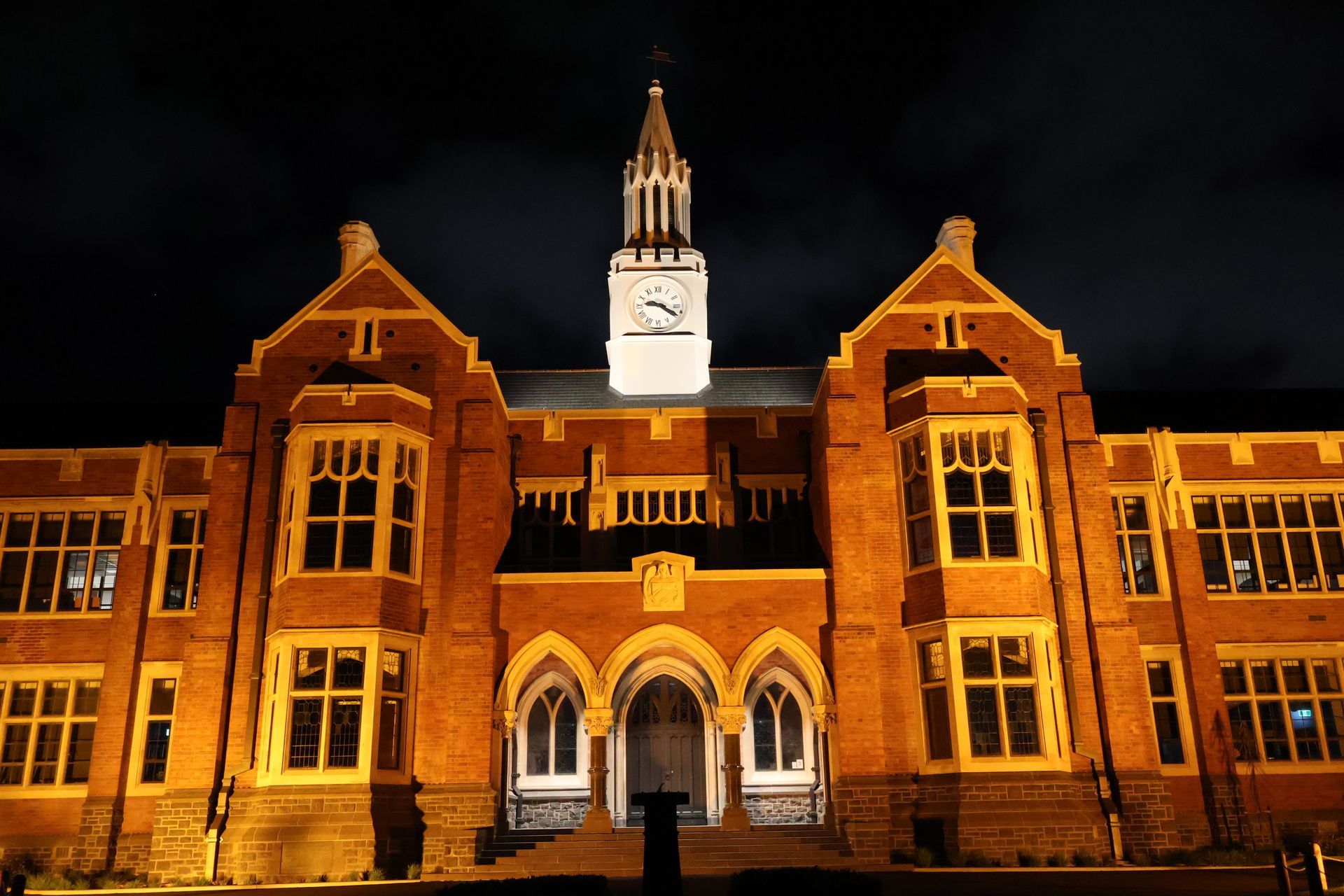 Christchurch Boys High School at night displaying lighting installed by Christchurch Electrical showing front archway and clock tower.