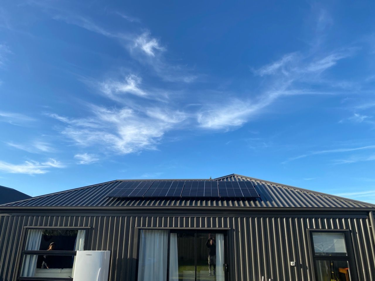 Black solar panel on residential roof in Christchurch, NZ.