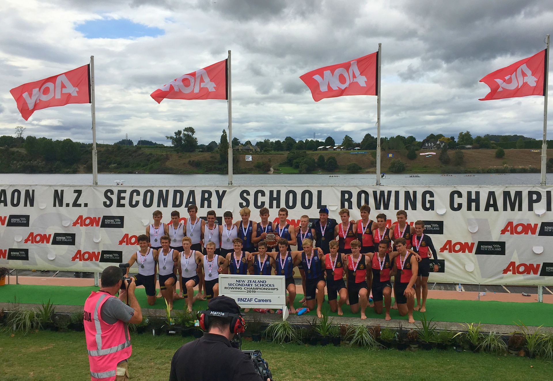 NZ Secondary Schools Rowing Championships 2019.  Photographers taking photos of the top 3 teams with CBHSR in top position.
