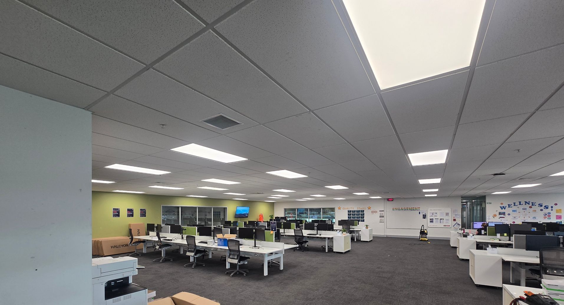 NZ Post lighting upgrade in offices as Christchurch Airport. Tile light fittings above workstations in office.