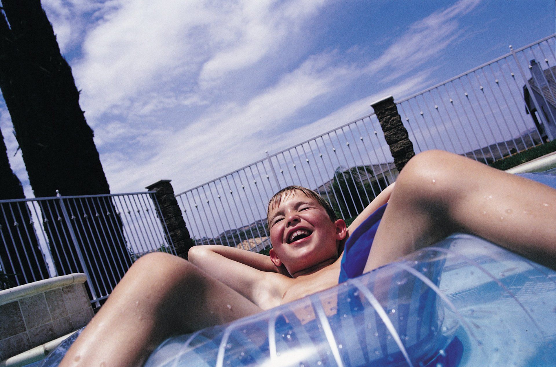 Boy On Inflatable Ring In Swimming Pool