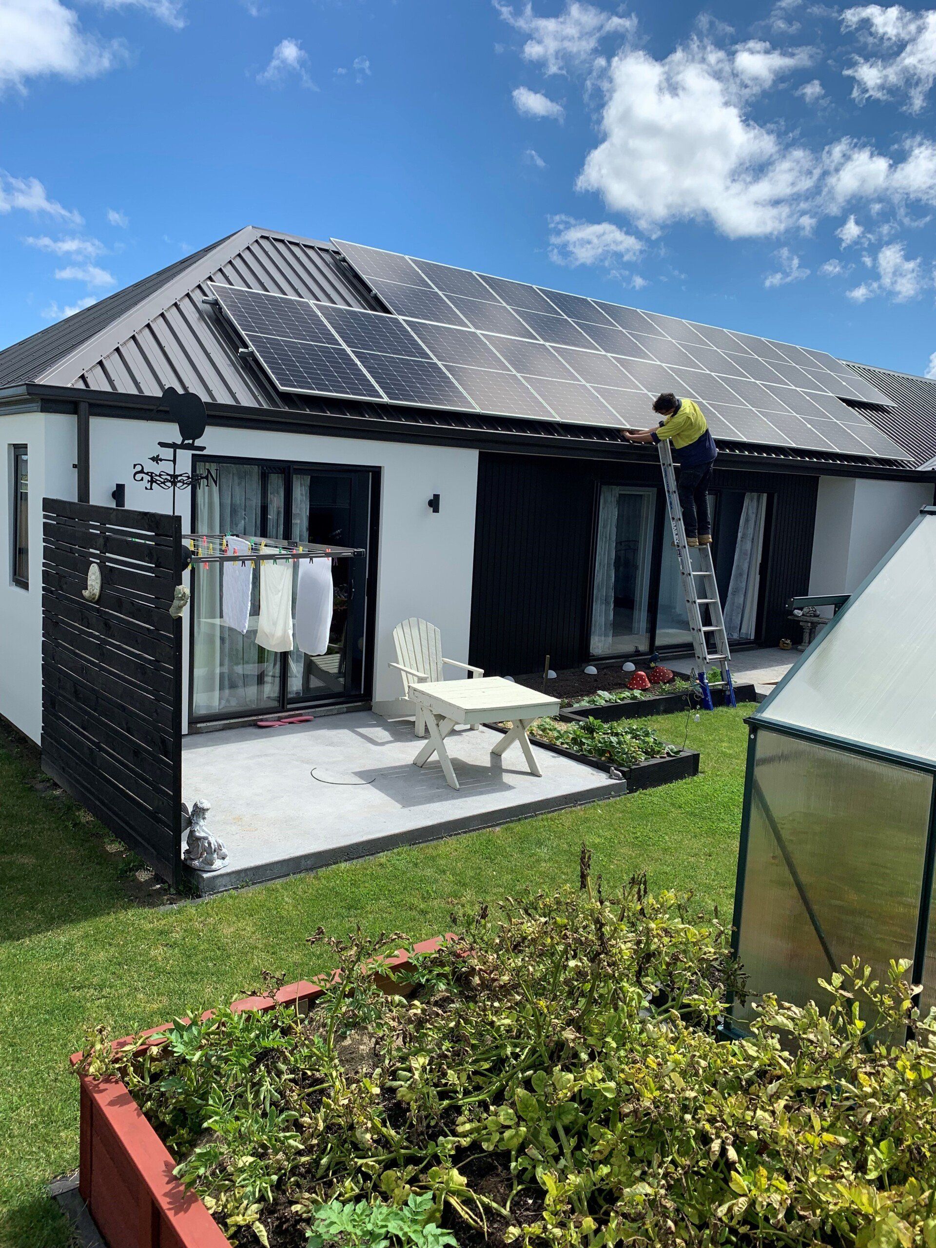 Black solar panels on white residential property
