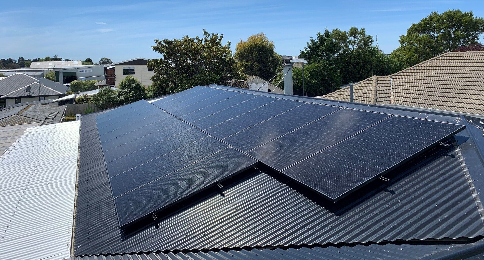Residential roof with black solar panels