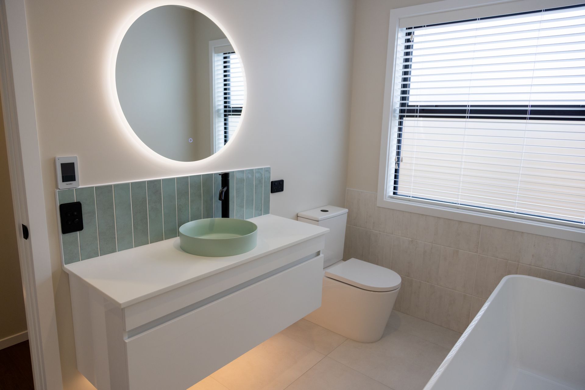 Residential bathroom with LED backlit mirror