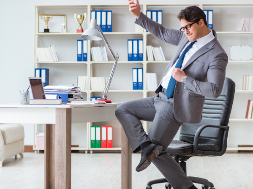 Man celebrating in office