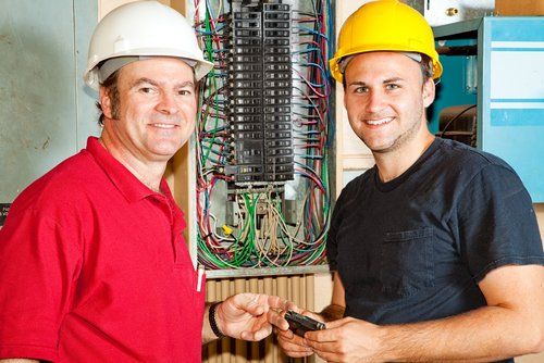 Master electrician with apprentice