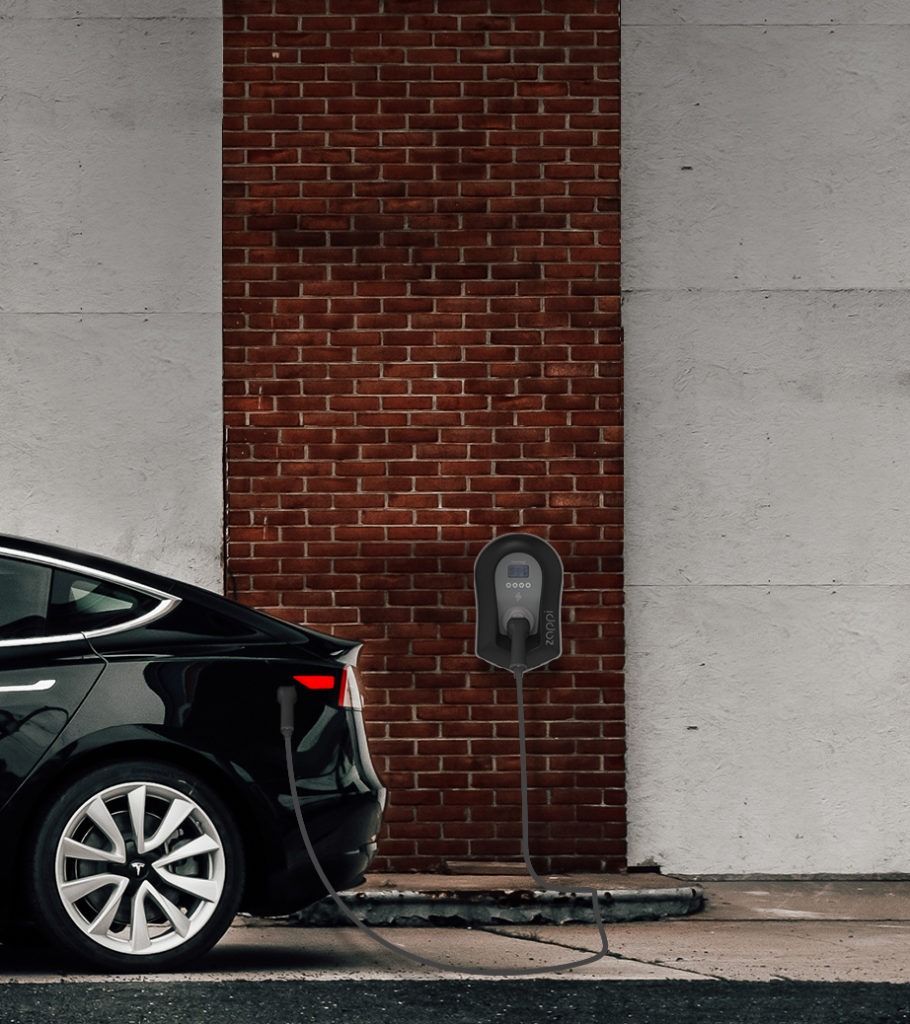 Car plugged into a Zappi EV Charger on wall