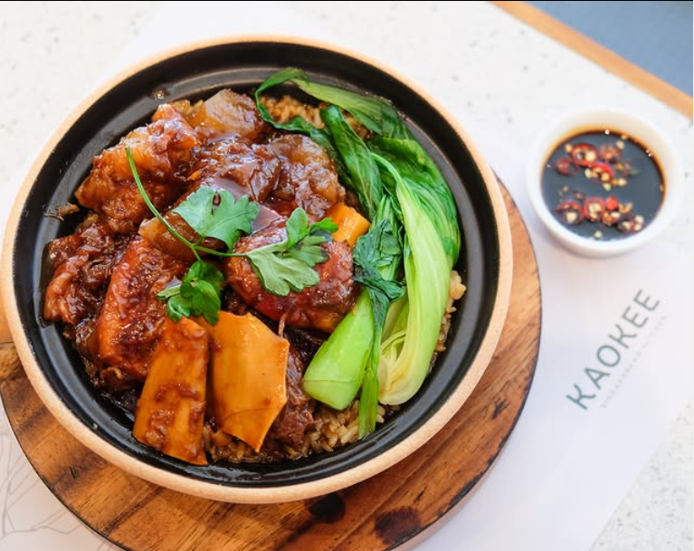 Bowl of savory stew with colorful vegetables and meat in a rich broth