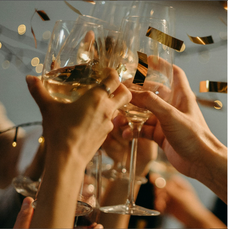 Friends enjoying a Makati staycation while toasting drinks in celebration at a social gathering