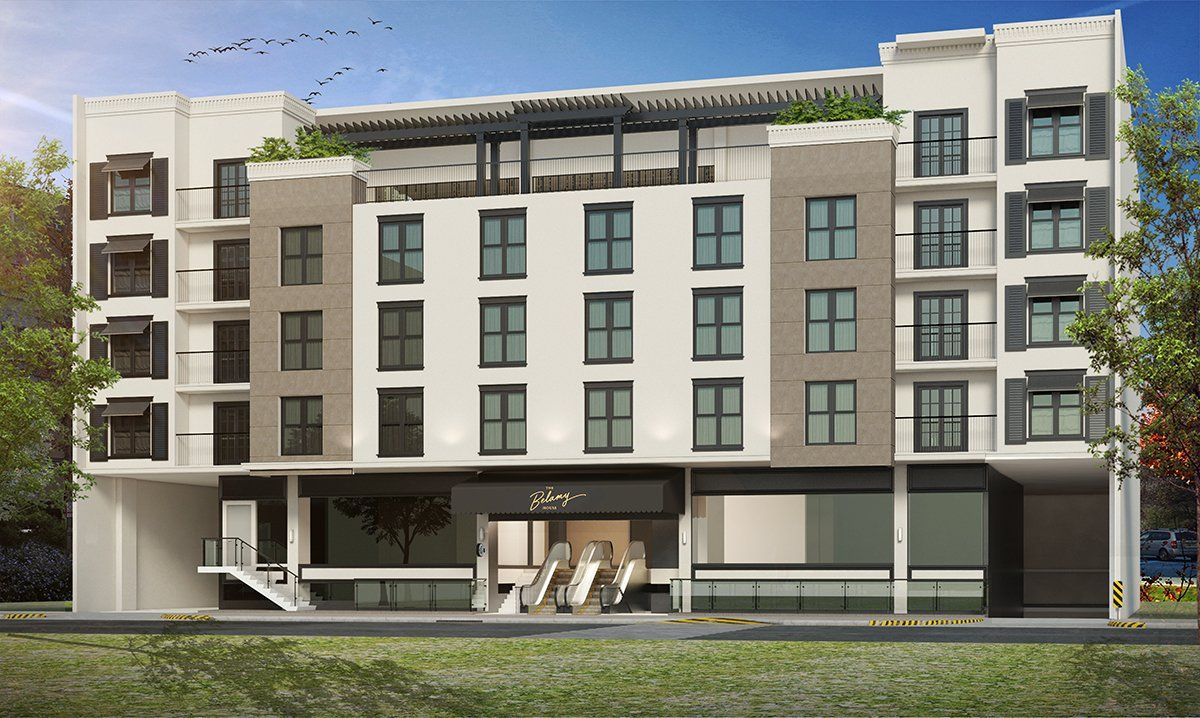 A modern, multi-story building with a ground-level entrance and multiple windows; exterior shot.