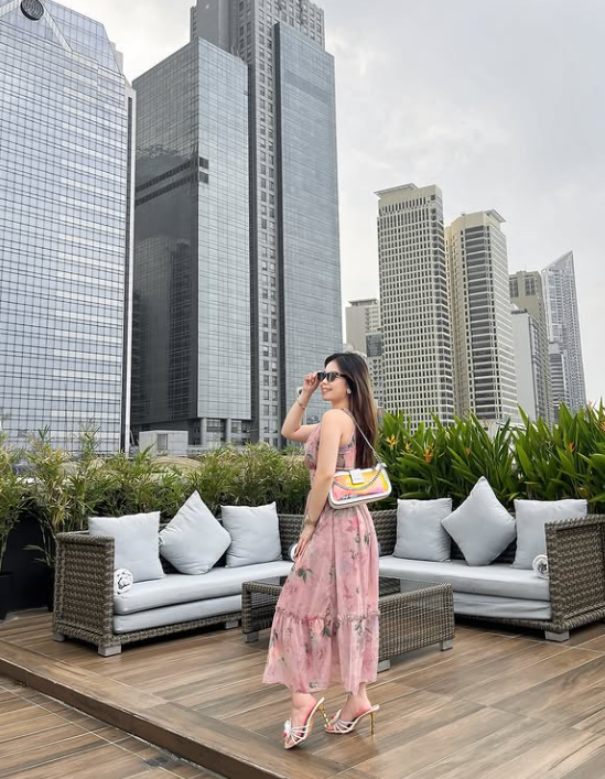 Guest on a rooftop with Makati city skyline in the background