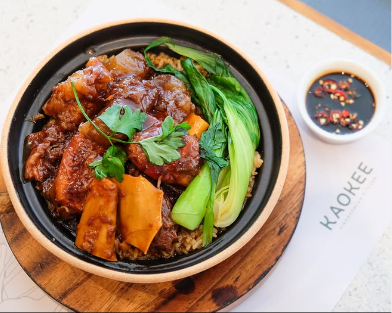 Traditional Filipino braised meat dish with bok choy served in a clay pot at an Makati restaurant