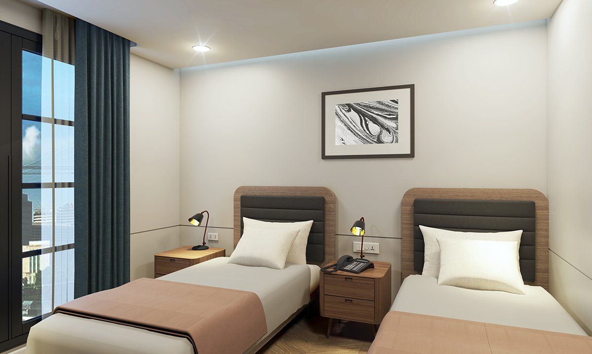 Two beds in a hotel room with nightstands, artwork, and a window with a view.