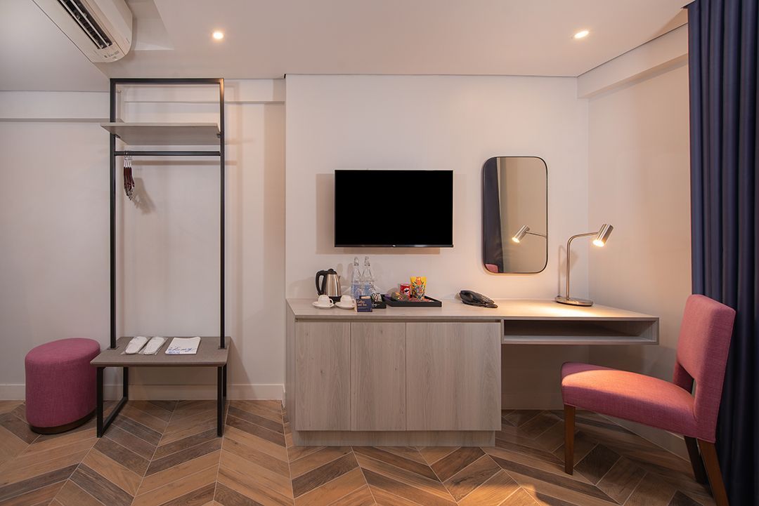 Desk, television, and other in-room amenities in The Belamy House