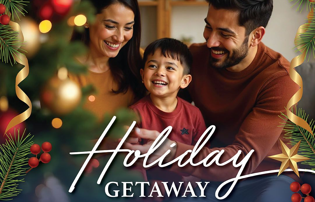 Family smiling near a Christmas tree;