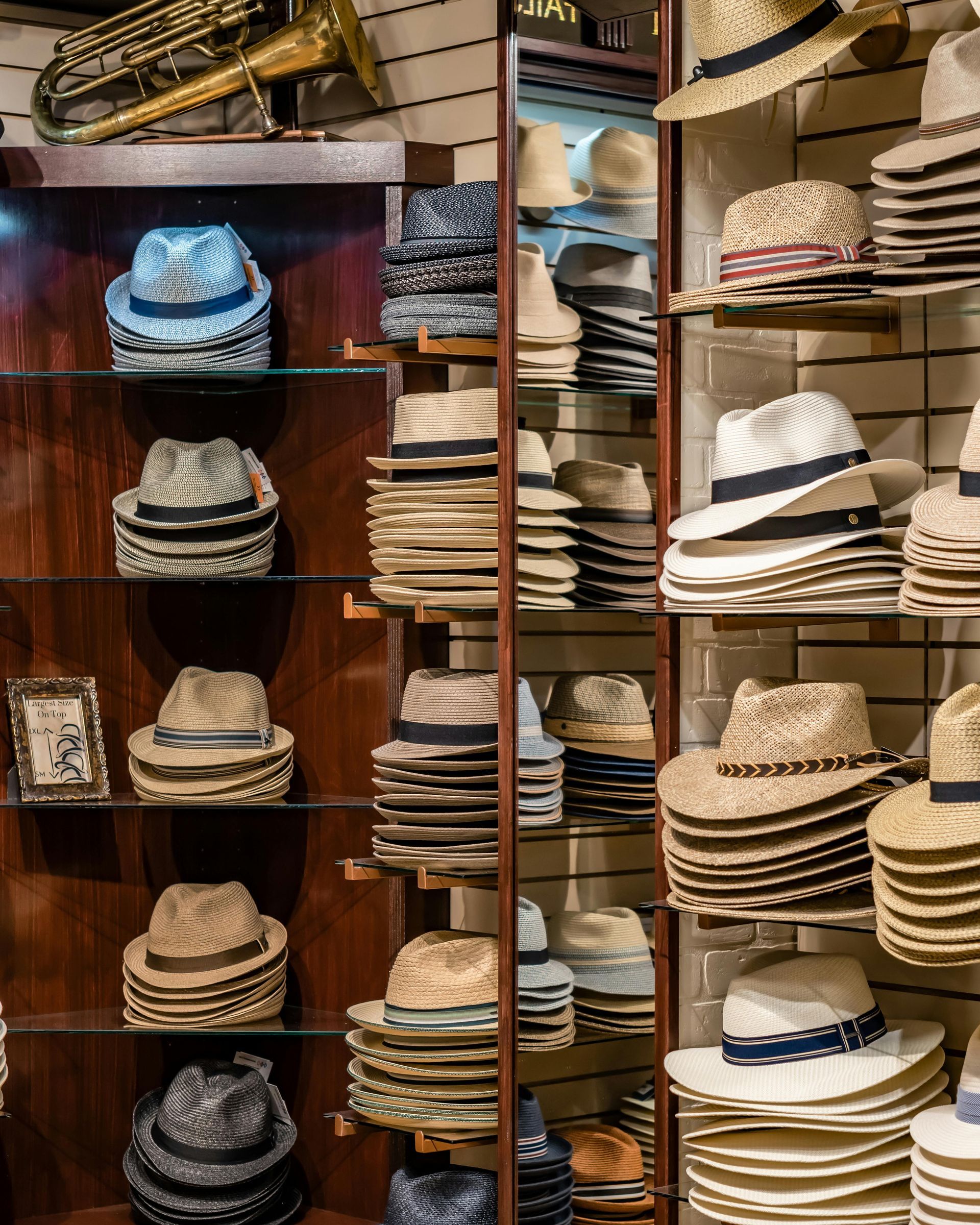 Hats displayed on shelves in a retail store; various styles and colors.