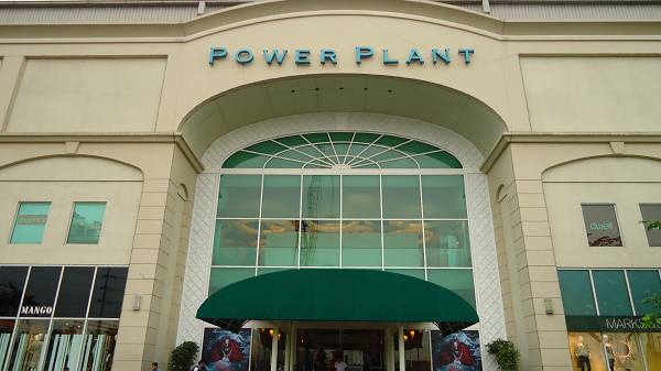 Power Plant mall entrance with teal letters and green awning.