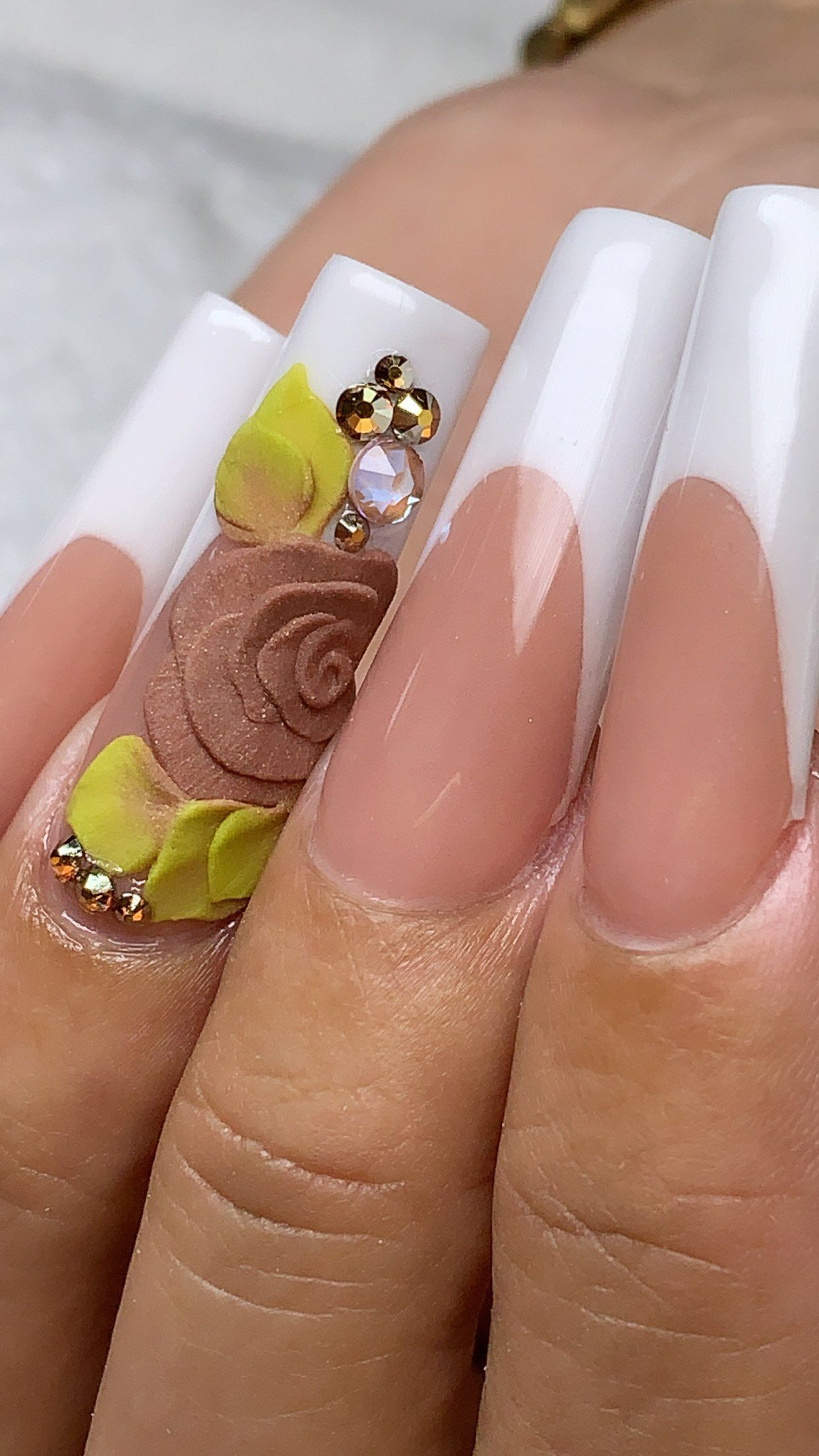 A close up of a woman 's nails with a french manicure.