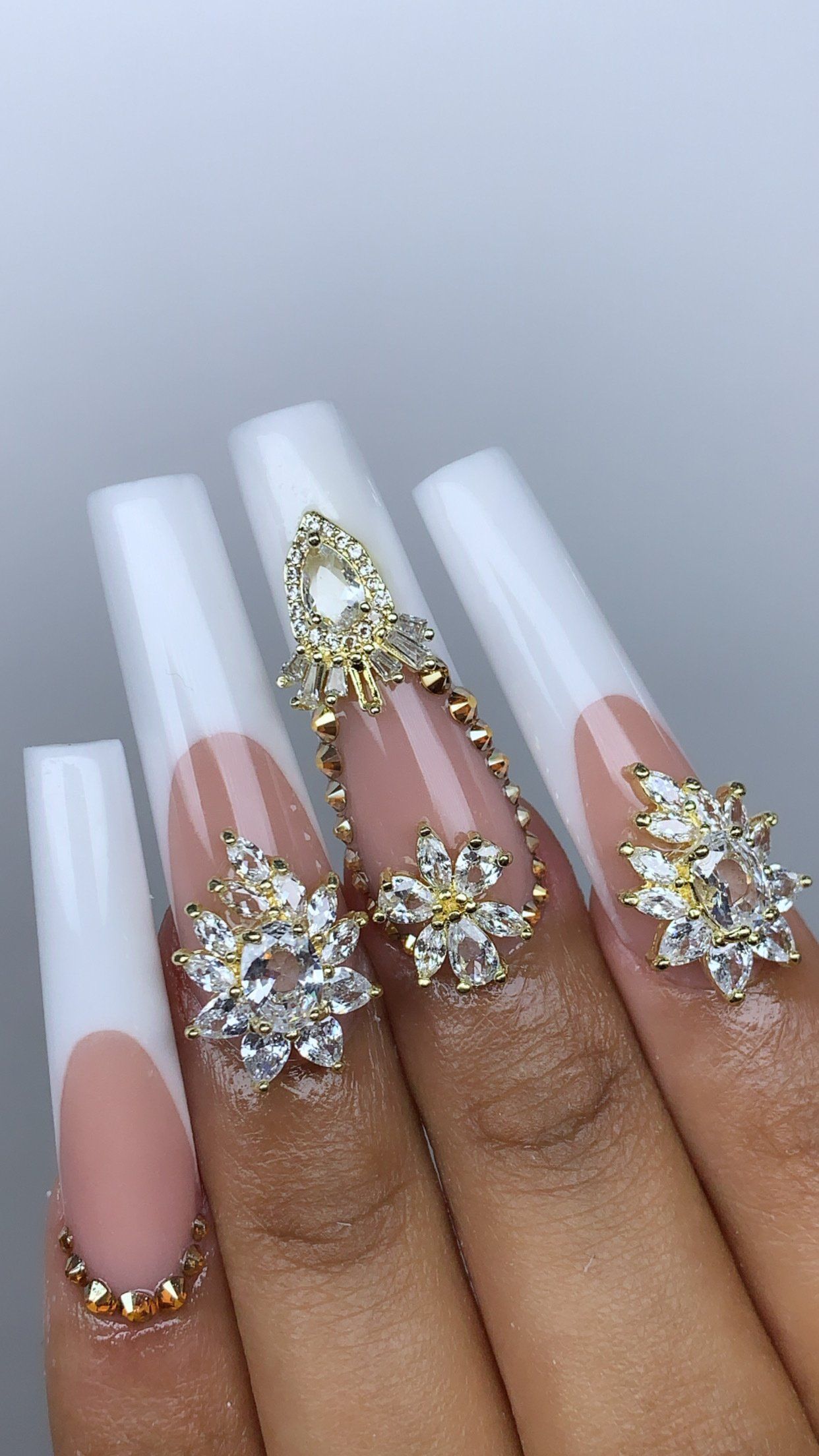 A close up of a person 's nails with rings on them.