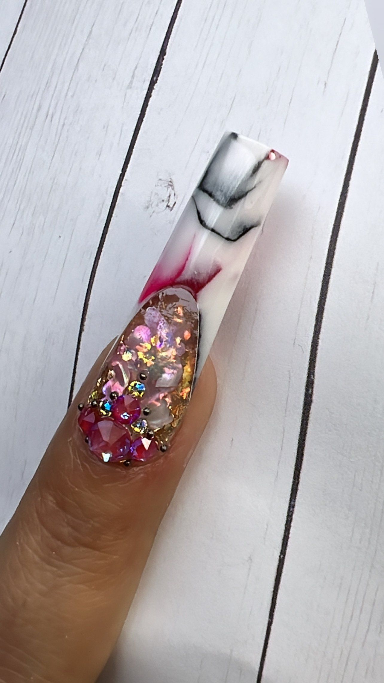 A close up of a woman 's nail with a design on it.
