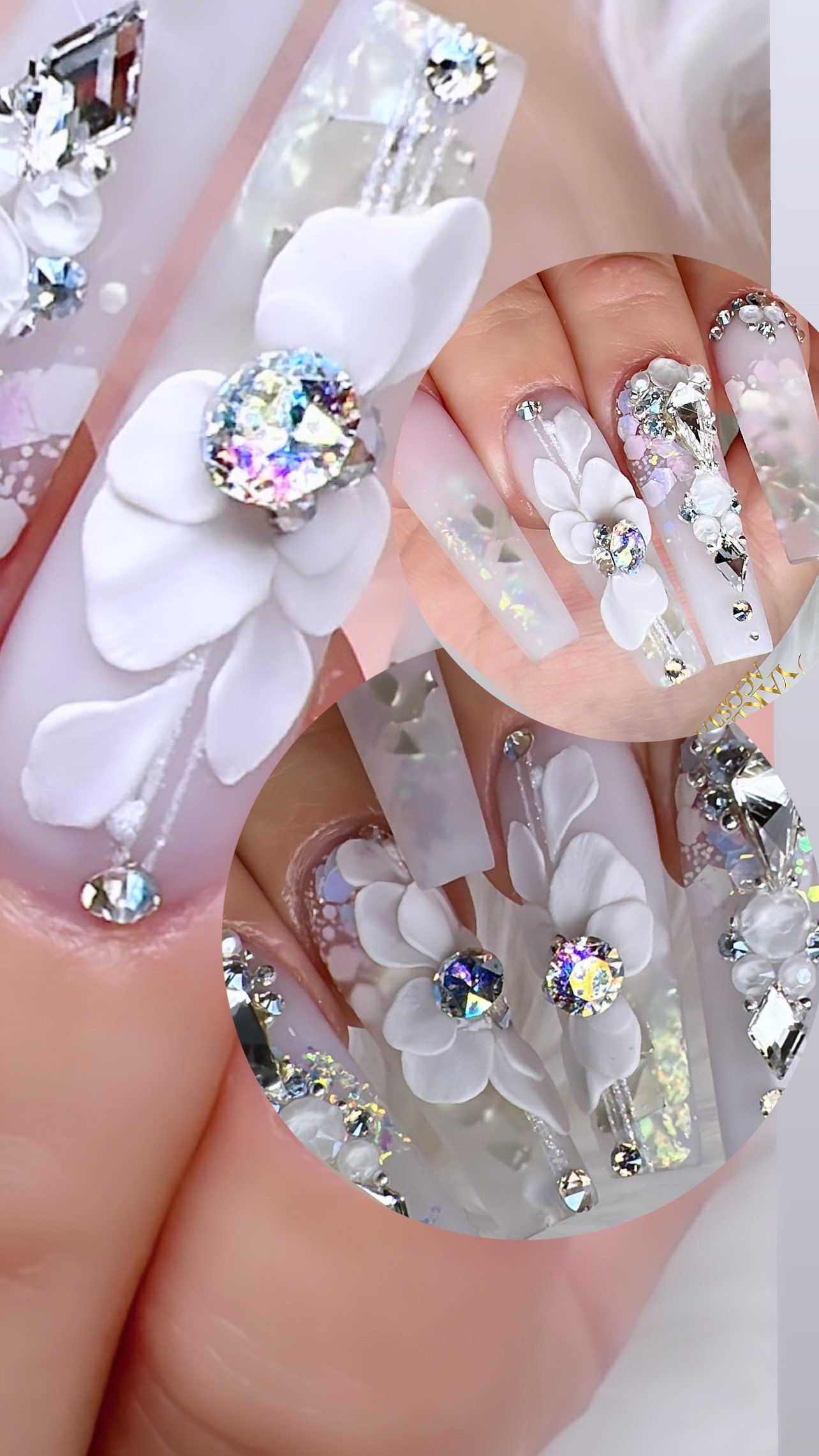 A close up of a woman 's nails with flowers and rhinestones.