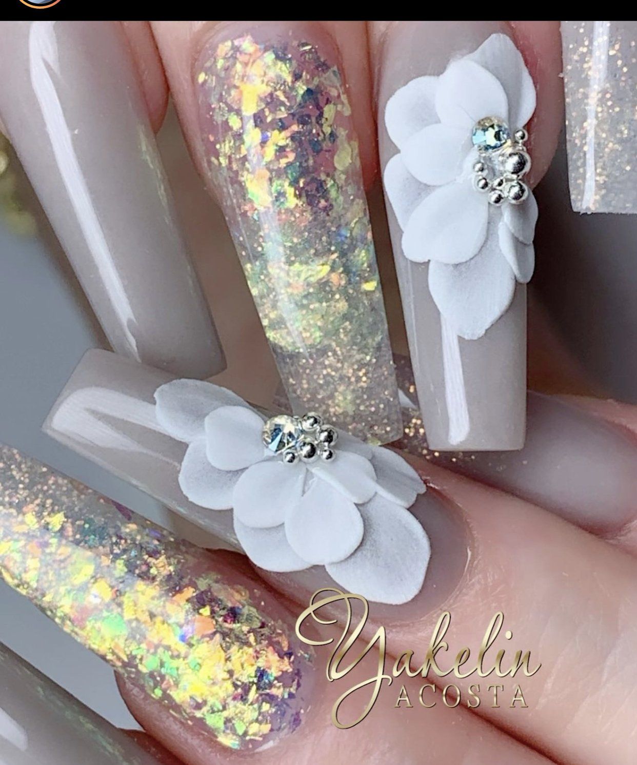 A close up of a woman 's nails with flowers on them