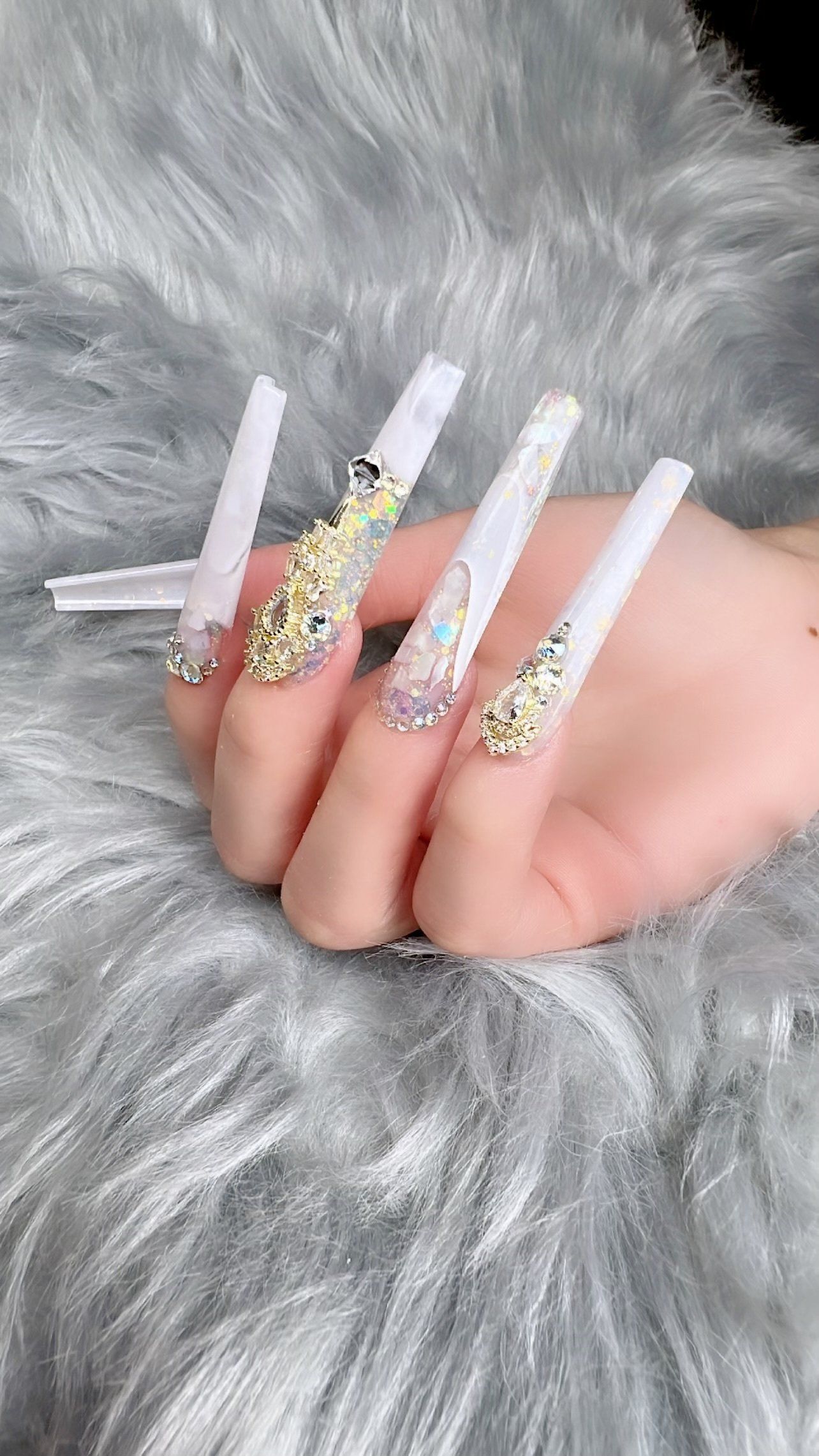 A close up of a person 's hand with long nails.